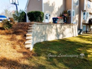A man is standing on the steps of his house.