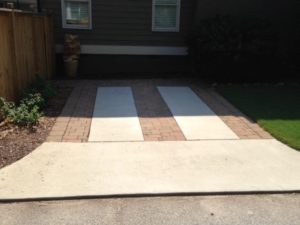 A driveway with a white and black striped mat.