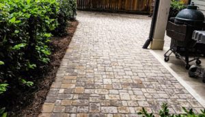 A walkway with brick and stone in the middle of it.