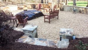 A patio with benches and stone walls