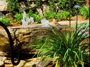 Small bird perched on rock fountain