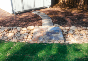 A garden with rocks and grass in the middle of it
