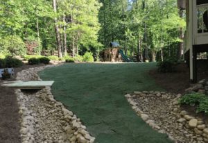 A green area with rocks and grass in the middle of it.