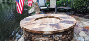A fire pit with a brick surround and stone surround.