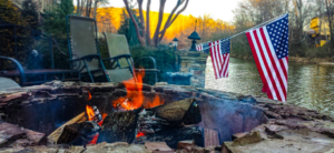 A fire with an american flag hanging over it.