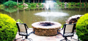 A fire pit sitting next to the water.