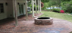 Brick patio with circular stone fire pit