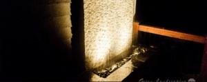 A stone wall with lights on it