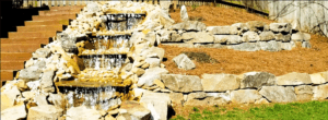A stone wall with water flowing down it.